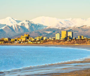 A view of downtown Anchorage as seen from across the bay with the mountains in the back