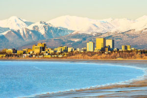 A view of downtown Anchorage as seen from across the bay with the mountains in the back